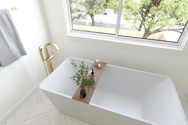 bathroom with a bath and tile patterned floors