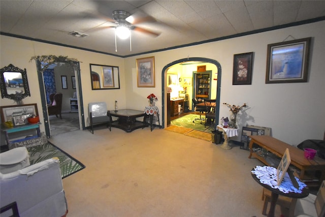 interior space featuring ornamental molding, carpet floors, and ceiling fan