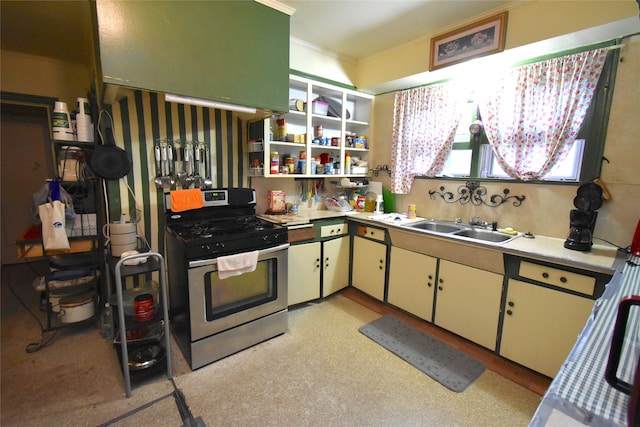 kitchen with sink, stainless steel gas range, and white cabinets