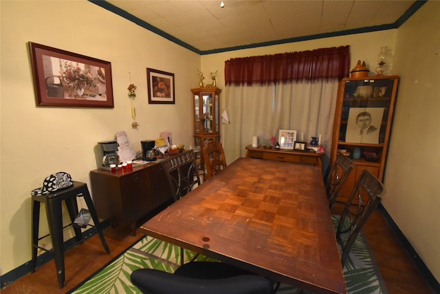 dining area with crown molding and dark parquet floors