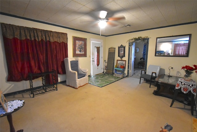 living area featuring ceiling fan and carpet