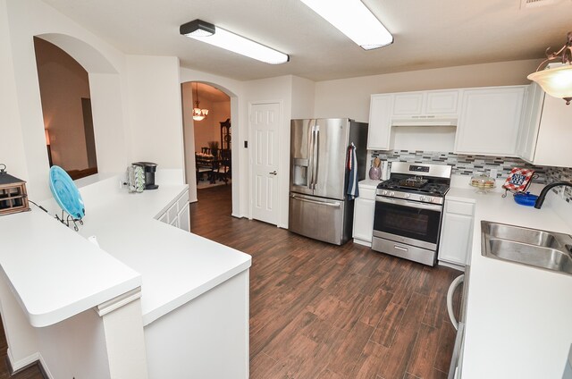 kitchen featuring dark wood-type flooring, decorative backsplash, sink, white cabinetry, and appliances with stainless steel finishes