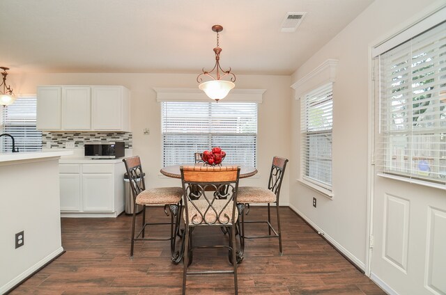 dining space with dark hardwood / wood-style floors