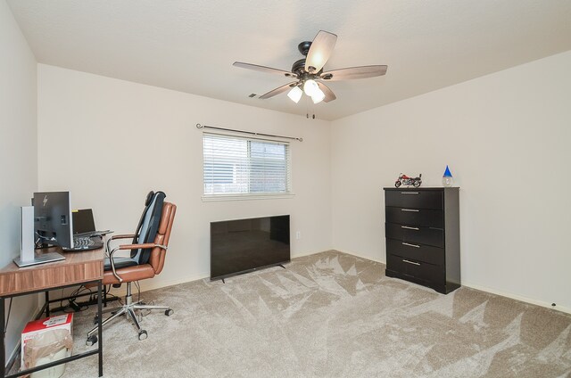 home office with light carpet and ceiling fan