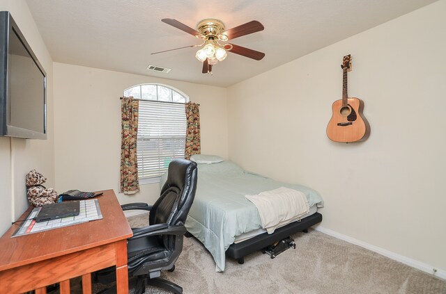 bedroom featuring light colored carpet and ceiling fan