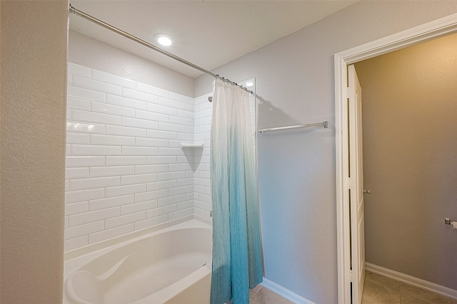 bathroom with shower / bath combo and tile patterned flooring