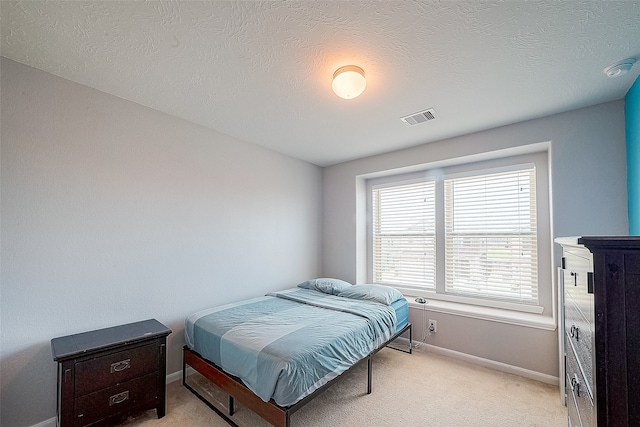 carpeted bedroom with a textured ceiling