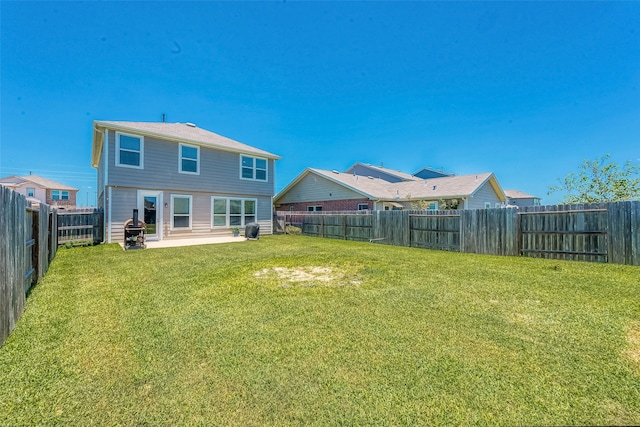 back of property with a lawn and a patio