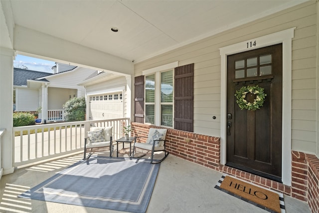 view of exterior entry with covered porch