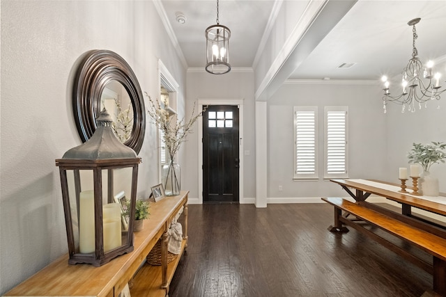 foyer entrance with crown molding, dark hardwood / wood-style floors, and a chandelier