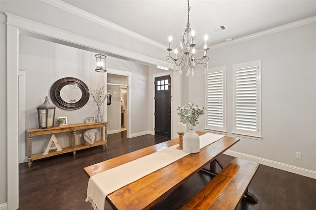 dining room with crown molding, dark hardwood / wood-style floors, and a chandelier