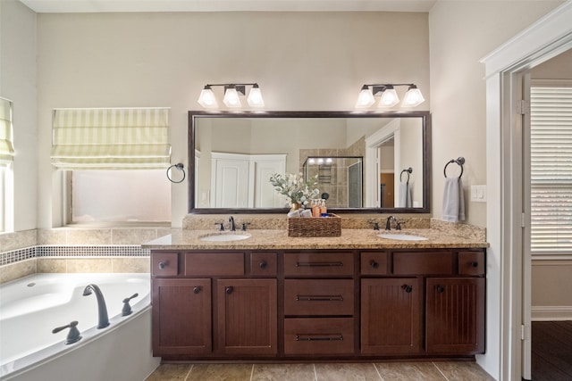 bathroom with vanity and shower with separate bathtub