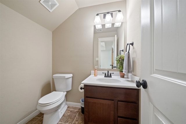 bathroom with vanity, lofted ceiling, toilet, and tile patterned floors