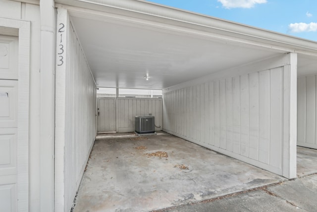 garage with central AC unit and a carport