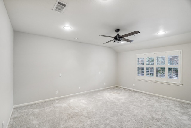 carpeted spare room featuring ceiling fan