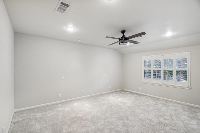 carpeted spare room with ceiling fan and lofted ceiling