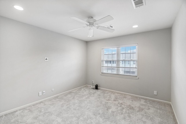 empty room with light colored carpet and ceiling fan