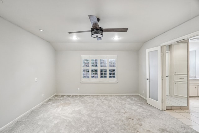 interior space featuring light carpet, lofted ceiling, and ceiling fan