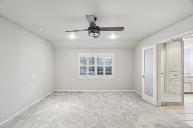 carpeted spare room with vaulted ceiling and ceiling fan