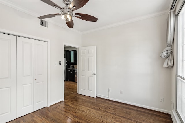 unfurnished bedroom featuring a closet, ceiling fan, ornamental molding, and dark hardwood / wood-style floors