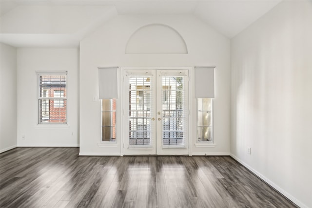 spare room with lofted ceiling, french doors, and dark hardwood / wood-style flooring