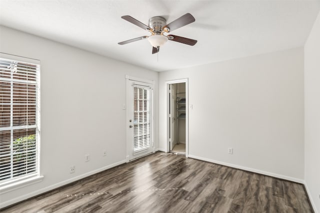 spare room featuring ceiling fan and dark hardwood / wood-style flooring