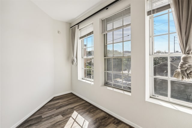 empty room with dark wood-type flooring