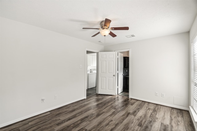 unfurnished bedroom featuring washer / dryer, dark wood-type flooring, and ceiling fan