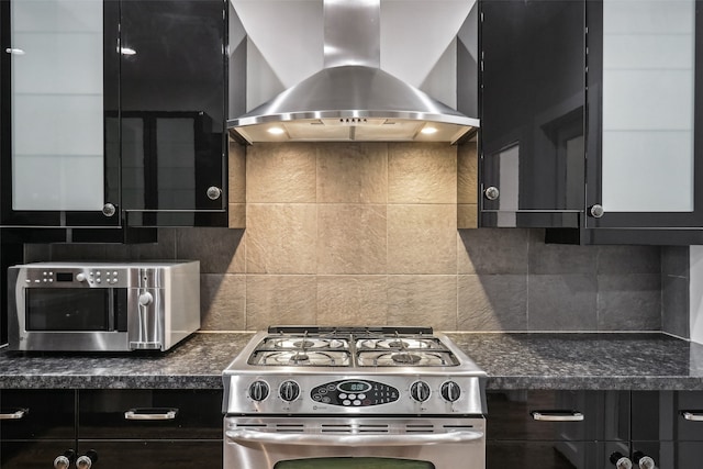 kitchen with wall chimney exhaust hood, stainless steel appliances, and backsplash