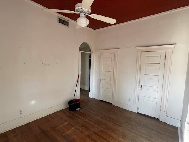 unfurnished bedroom featuring dark wood-type flooring and ceiling fan