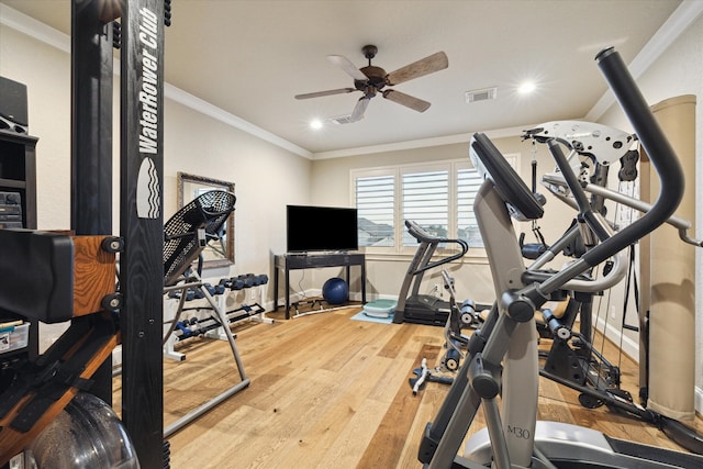 exercise room with wood-type flooring, ceiling fan, and crown molding