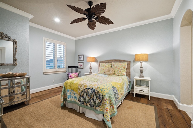 bedroom with ceiling fan, crown molding, and dark wood-type flooring