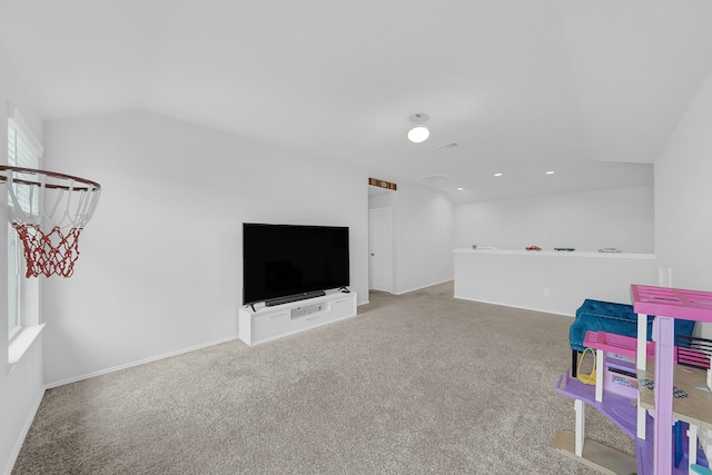 recreation room featuring light carpet and vaulted ceiling