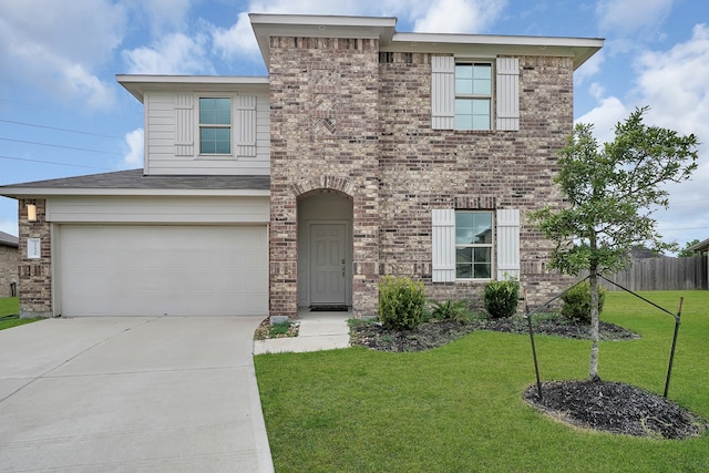 view of front of home featuring a front lawn and a garage