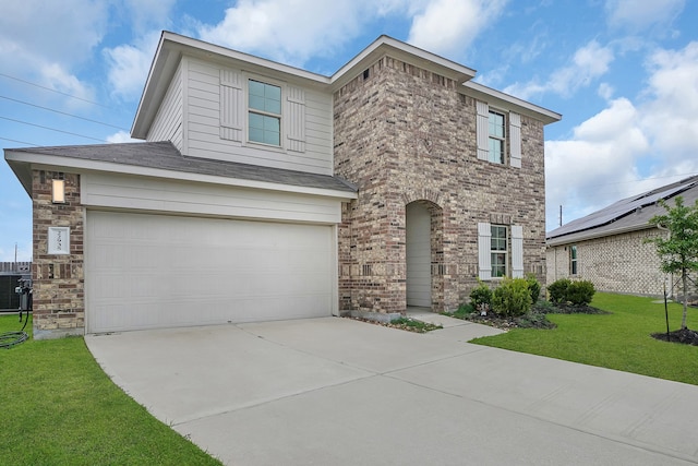 view of front of home with a garage and a front lawn