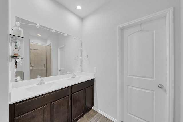 bathroom featuring vanity, an enclosed shower, and hardwood / wood-style flooring