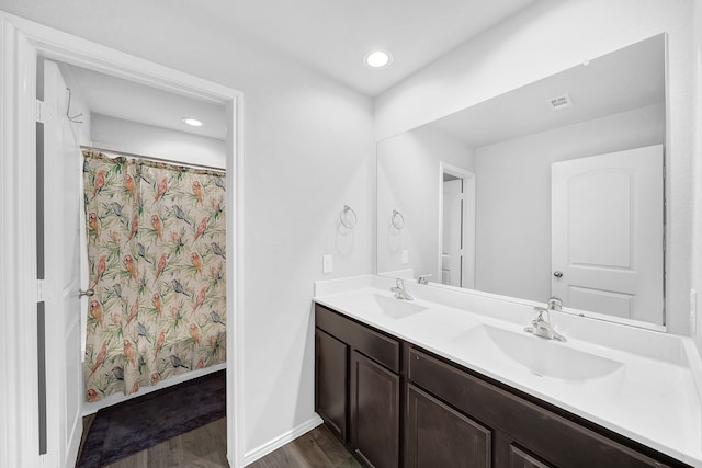 bathroom featuring vanity, hardwood / wood-style floors, and curtained shower