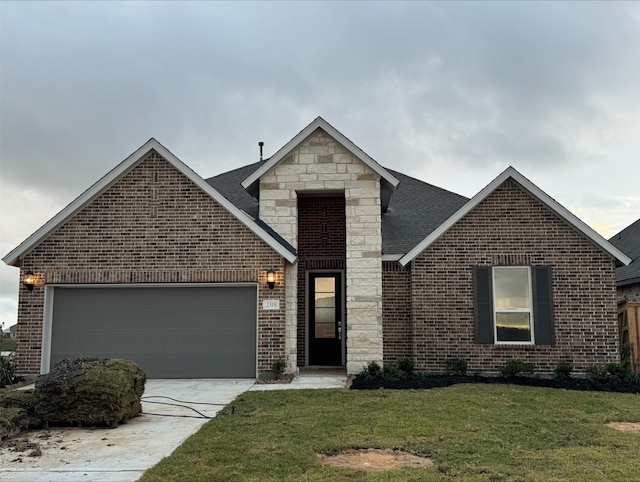 view of property with a garage and a front lawn