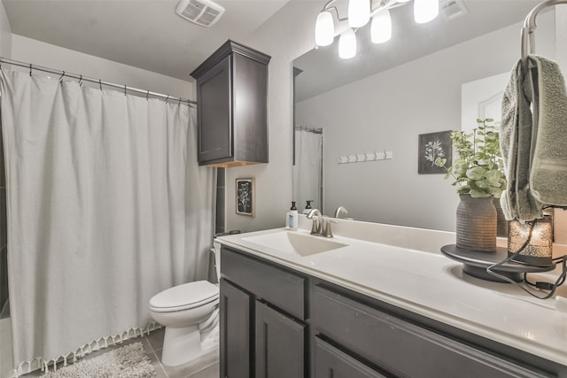 bathroom featuring vanity, toilet, and tile patterned floors