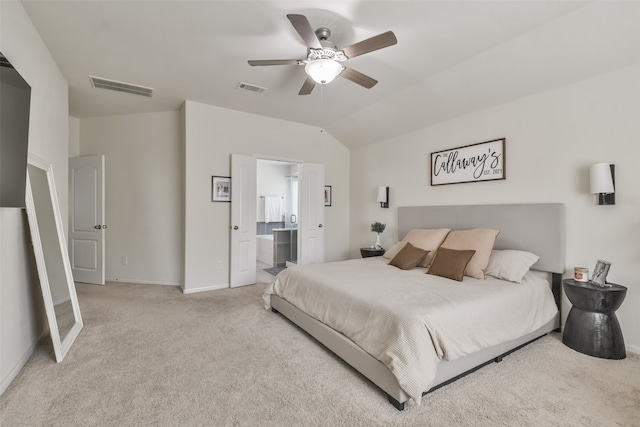 carpeted bedroom featuring ceiling fan, connected bathroom, and vaulted ceiling