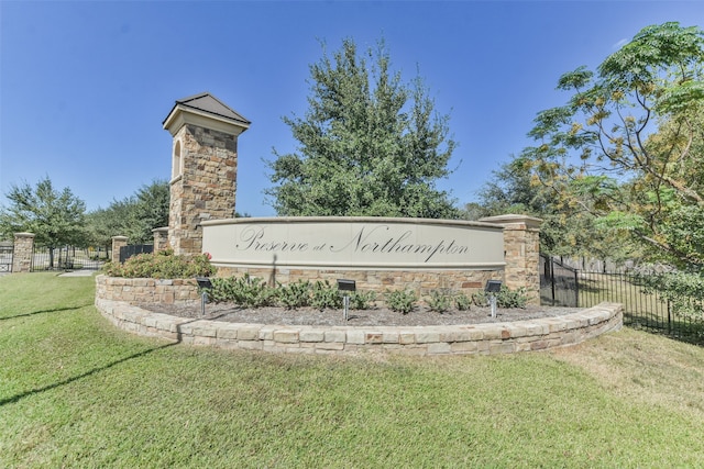 community sign featuring a lawn