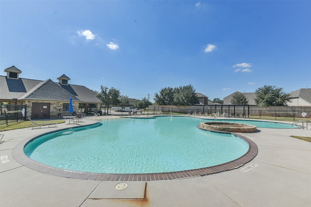 view of pool featuring a hot tub and a patio area