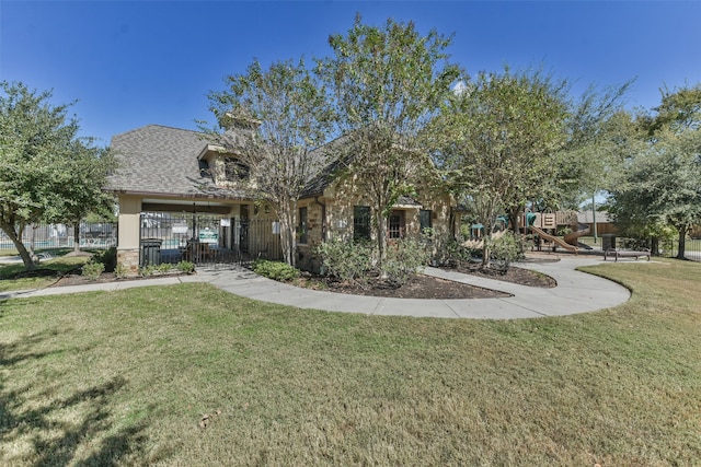 view of front facade with a playground and a front lawn