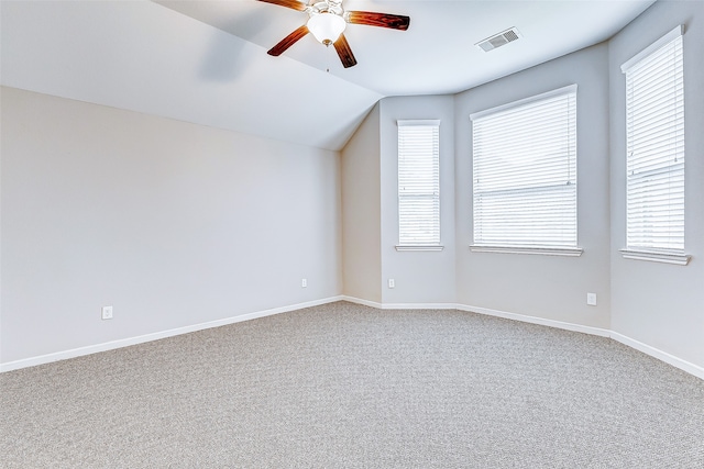 additional living space featuring carpet floors, a wealth of natural light, lofted ceiling, and ceiling fan