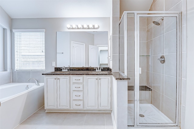 bathroom with tile patterned flooring, shower with separate bathtub, and vanity