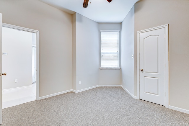 unfurnished room featuring light carpet and ceiling fan