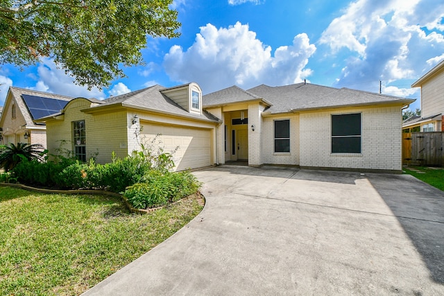 view of front of house with a front lawn and a garage