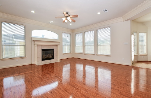 unfurnished living room with ornamental molding, a healthy amount of sunlight, and light hardwood / wood-style flooring