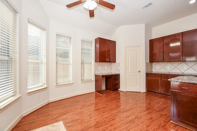 kitchen featuring backsplash, hardwood / wood-style floors, and plenty of natural light