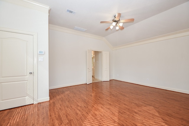 unfurnished room featuring hardwood / wood-style flooring, ceiling fan, vaulted ceiling, and ornamental molding